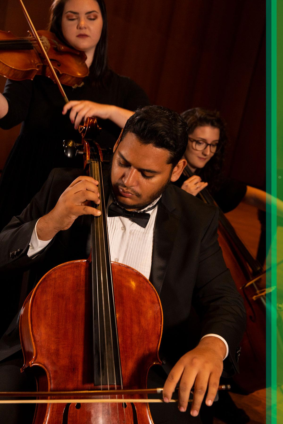 Three music students perform in Terry Concert Hall.